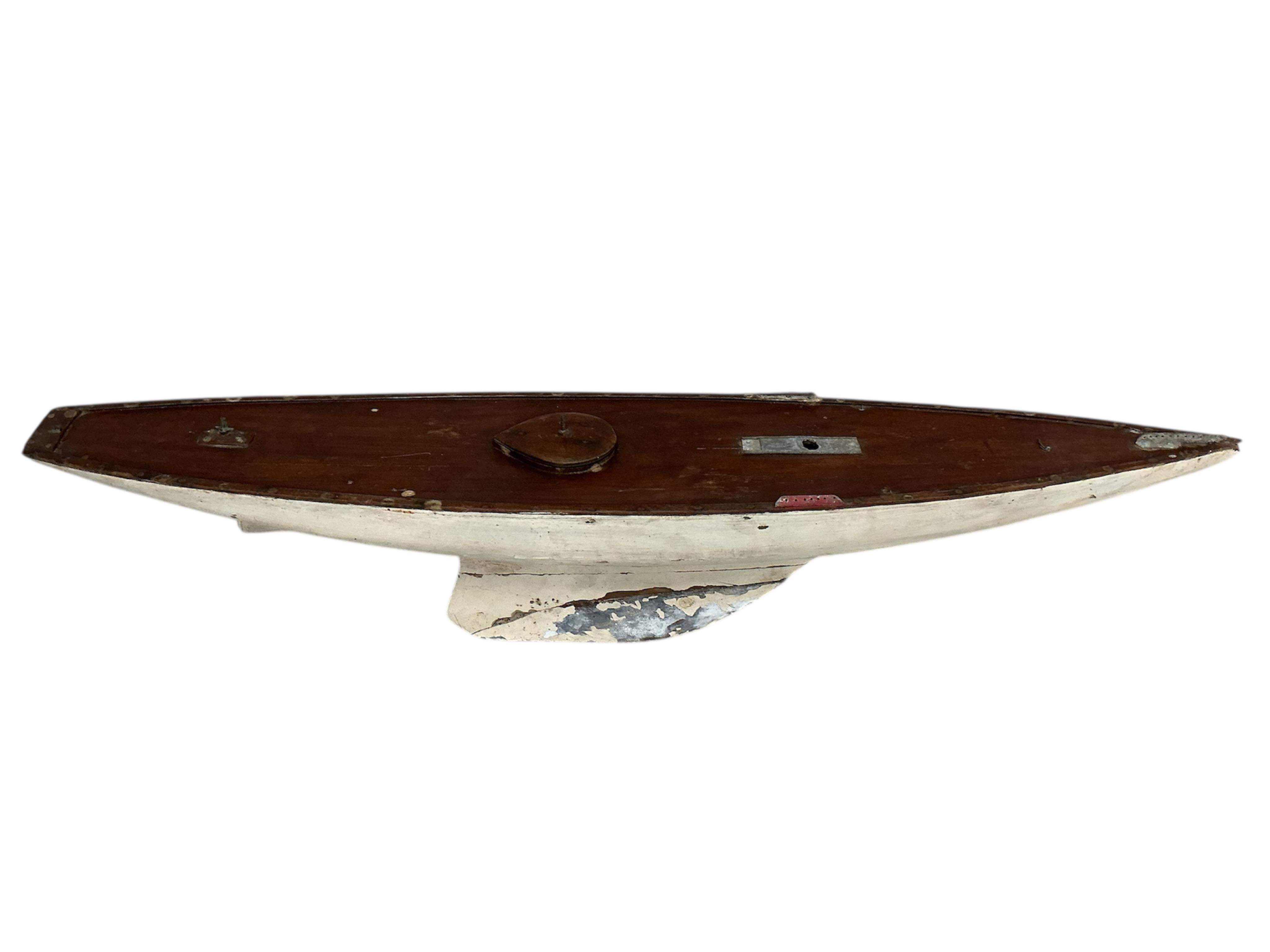 An early 20th century painted pond yacht, lacking sails, length 128cm